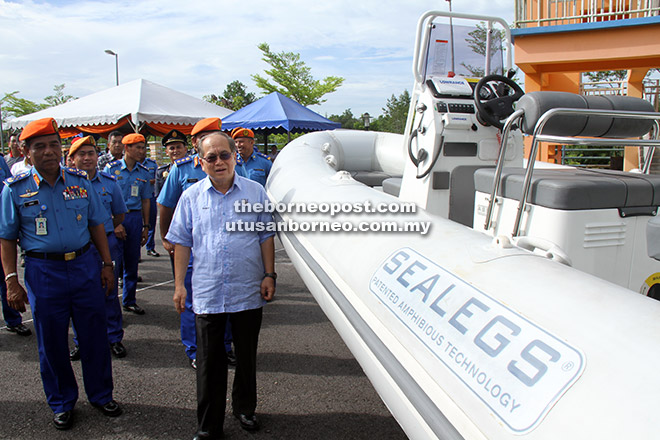  Uggah diiringi Azmy (kiri) melihat bot Sealegs yang diserahkan kepada APM Sarawak, semalam.