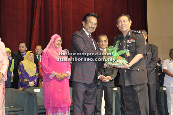  Musa (kiri) menyampaikan sumbangan kuih hari raya kepada Pengarah Jabatan Penjara Negeri Sabah Suria Idris (kanan) sambil diperhatikan Sukarti (tengah). 