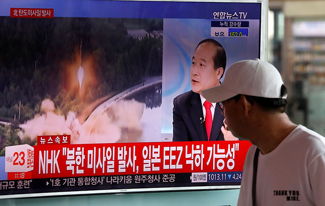  Seorang lelaki melihat siaran televisyen yang memaparkan laporan berita mengenai ujian misil balistik Korea Utara, di sebuah stesen kereta api di Seoul, semalam. — Gambar Reuters