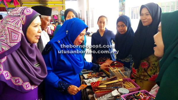  Jainab (dua kiri) bersama Siti Salmiah (kiri) melawat tapak gerai jualan pelajar pada majlis itu.