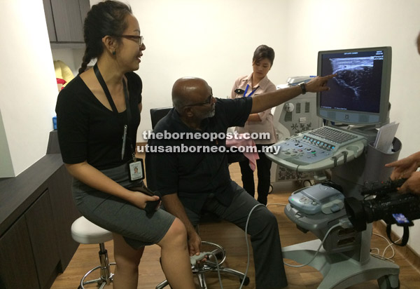  Charles membuat demonstrasi pemeriksaan ‘ultrasound’ kaki terhadap seorang kakitangan Hospital GKK.