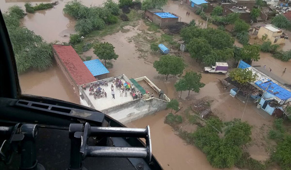  Gambar serahan Kementerian Pertahanan India kelmarin yang dirakam sehari sebelumnya menunjukkan mangsa banjir berkumpul di atas bumbung bangunan, termasuk seorang pesakit yang memerlukan dialisis buah pinggang, seperti yang dilihat dari atas helikopter Tentera Udara India (IAF) di kampung Abiyana, daerah Patan, 220 kilometer dari Ahmedabad. — Gambar AFP