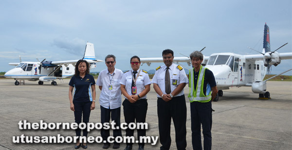  (Dua dari kanan) Irwin, Kam dan Chan bersama kakitangan LLA yang lain semasa meninjau pesawat yang dikendalikan syarikat itu.