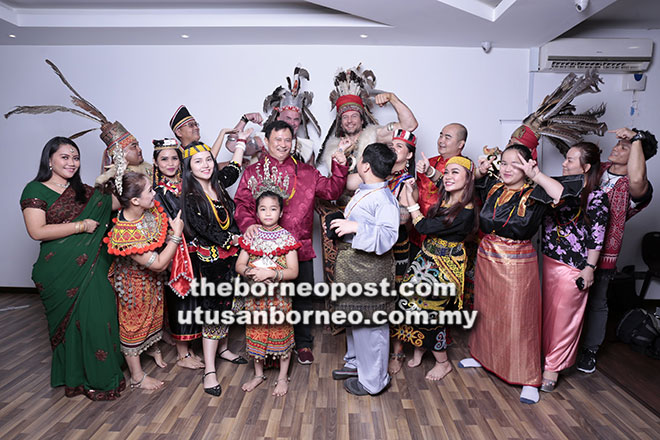  Devon (barisan belakang, kanan) dan Murray (dua kiri) memberi ‘pose’ istimewa sambil menggayakan pakaian tradisional Iban semasa sesi fotografi bersama Matthew (barisan belakang, kiri), Stephen (barisan tengah, tiga kanan), Teng (barisan tengah, lima kanan) dan yang lain.