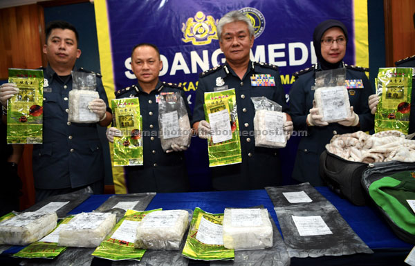  Hamzah (dua kanan) bersama anggotanya menunjukkan rampasan dadah jenis syabu ketika pemeriksaan di Lapangan Terbang Antarabangsa Kota Kinabalu (KKIA), semalam. — Gambar Bernama