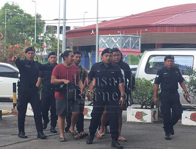 Lima tertuduh warga Brunei diiringi anggota polis selepas dijatuhi hukuman hari ini.