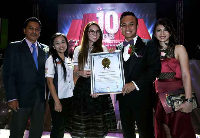  Lawrence Teo (dua, kanan) menerima sijil Malaysia Book of Records (MBOR) daripada Pengarah Pembangunan Perniagaan MBOR Gillian Ooi (tengah) sempena sambutan Ulang Tahun Ke-10 Affilate Junction (AJ) semalam. — Gambar Bernama