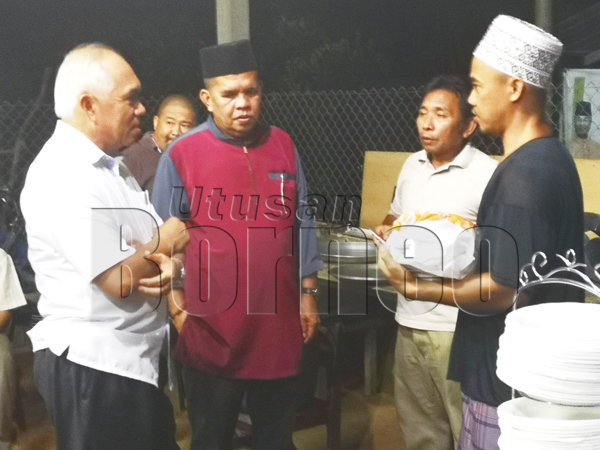PENGERUSI penganjur, Abdullah Pungut (dua kiri) beramah mesra bersama Yusof dan pengunjung majlis kenduri kesyukuran dan ibadah korban di Kg Batu 7 Pantai Sipitang.
