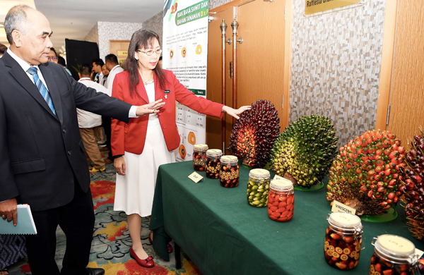 TERESA diberi taklimat oleh Pengerusi Lembaga Minyak Sawit Malaysia Tan Sri Mohd Bakke Salleh tentang jenis baka sawit pada pameran sempena Persidangan Kebangsaan Pekebun Kecil Sawit 2018 hari ini.