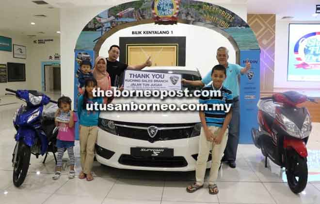  Suria (depan, empat kiri depan) dan anak-anaknya merakamkan kenangan bersama kereta Proton Suprima S Turbo 1.6T yang dimenangi semalam. Turut kelihatan Pengurus Jualan Proton, Jeremy Chan (lima kiri belakang).