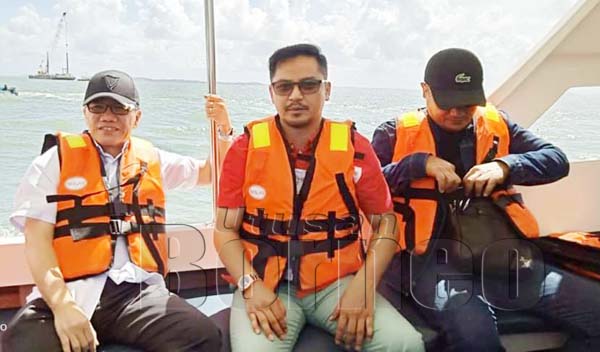 LIEW (kiri) bersama Setiausaha Sulit Mohd Hanapiah Sahih Haji Mantoi menaiki bot ke Pulau Timbang, Batu Sapi.