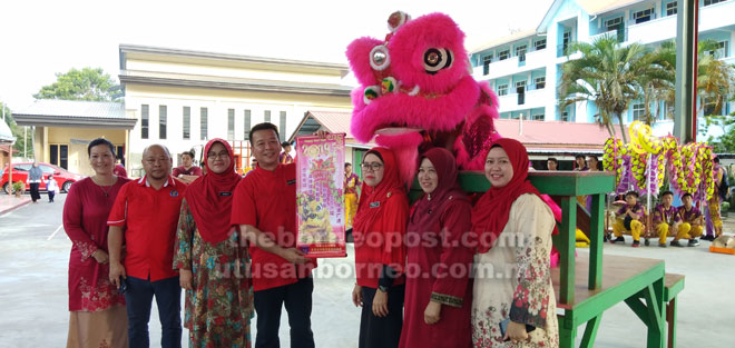  Ahmad (empat kiri) menerima ucapan TBC dari kumpulan tarian singa. 