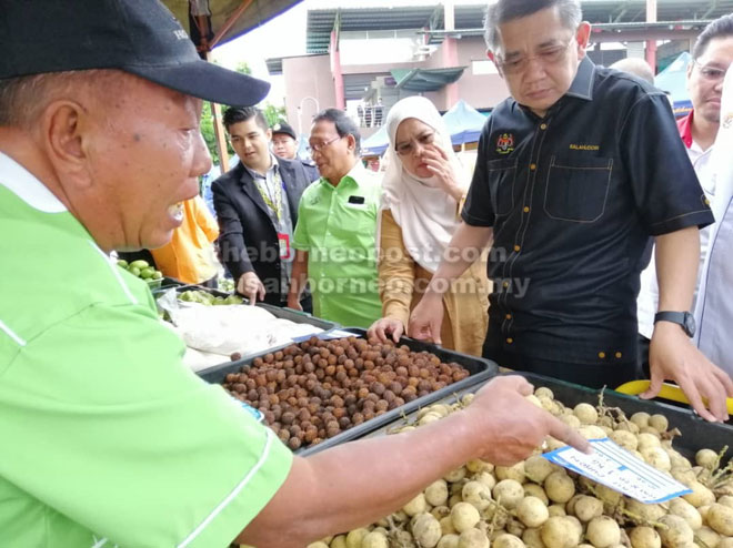  Salahuddin (kanan) bertanyakan harga buah-buahan kepada salah seorang peniaga di Pasar Tani Daro semalam.