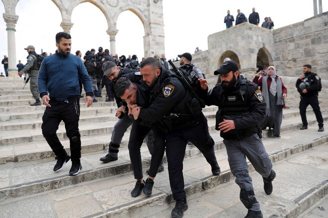  Anggota polis Israel menahan seorang penunjuk perasaan Palestin sewaktu pertelingkahan berlaku,                                           selepas penunjuk perasaan cuba memecah mangga pada pagar di pekarangan Masjid Al-Aqsa di Kota Lama Baitulmuqaddis                          pada Isnin lepas, setelah ia ditutup oleh polis Israel. — Gambar AFP