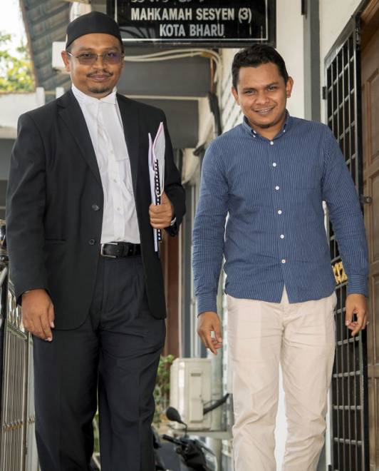  Mohd Faizu bersama peguamnya Shaharuddin (kiri) tersenyum setelah berjaya mendapat ganti rugi am di atas kecederaan di telinga kiri akibat ditampar anggota polis empat tahun di Mahkamah Sesyen 3, Kota Bharu, semalam. — Gambar Bernama
