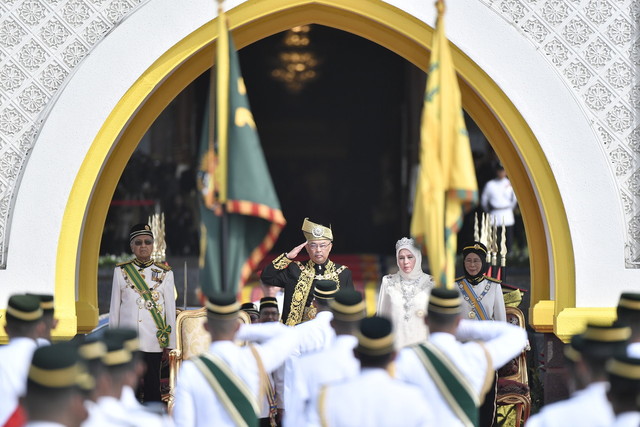 Sultan Abdullah dan Tunku Azizah berkenan memberi tabik hormat ketika memeriksa pasukan Kawalan Kehormat Utama yang dibarisi 107 anggota Batalion Pertama Rejimen Askar Melayu Diraja (RAMD) sempena istiadat pertabalan baginda di Istana Negara hari ini. - Gambar Bernama 