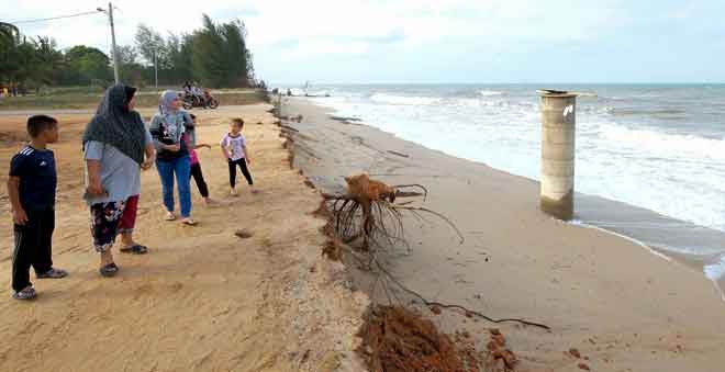  Orang ramai melihat sebuah perigi yang kini tidak dapat digunakan berikutan hakisan pantai yang berlaku ketika tinjauan di Pantai Pengkalan Maras, Kuala Nerus semalam. — Gambar Bernama
