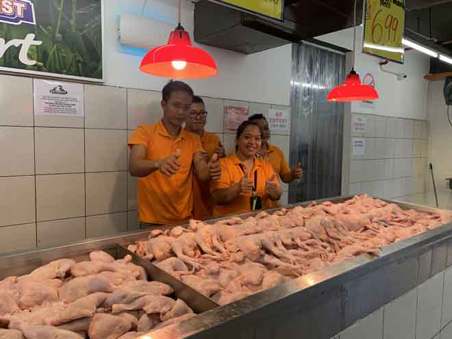  Kakitangan Nutribest Fresh Mart menunjukkan tanda bagus bagi ayam segar yang dijual kepada pelanggan.