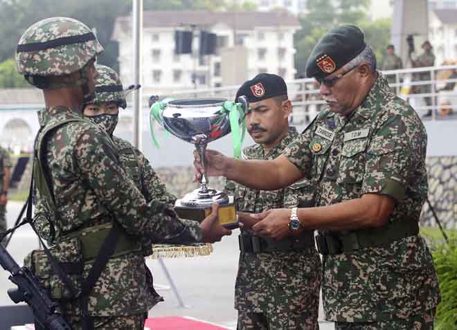  Muhamad Azumi menerima Anugerah Perajurit Muda Keseluruhan Terbaik yang disampaikan Zamrose (kanan) pada acara Perbarisan Tamat Latihan Perajurit Muda Tentera Darat Malaysia Lelaki Siri 191/19 di Pusat Latihan Asas Tentera Darat (PUSASDA), Port Dickson semalam. Seramai 1,782 perajurit muda menamatkan Kursus Asas Latihan Tentera Darat dalam suasana norma baharu semalam. — Gambar Bernama