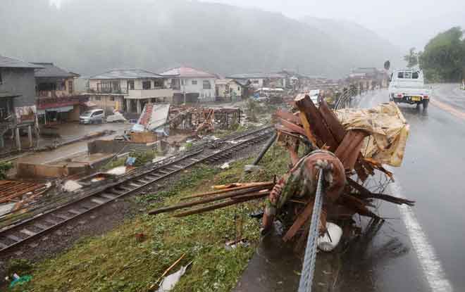  Puing berselerakan di sepanjang landasan kereta api susulan hujan lebat di Kuma, wilayah Kumamoto semalam.— Gambar AFP