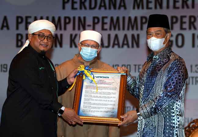  Muhyiddin (kanan) menerima Resolusi daripada Nasrudin (kiri) pada Majlis Perjumpaan Khas Perdana Menteri bersama Pemimpin Pemimpin Pertubuhan Islam Bukan Kerajaan (NGO Islam) di Dewan De’ Seri Endon Puspanitapuri, Putrajaya, semalam. — Gambar Bernama
