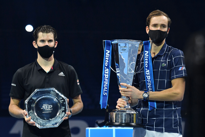 Medvedev (kanan) dan Thiem memakai pelitup muka bergambar dengan trofi selepas perlawanan di O2 Arena di London kelmarin. — Gambar AFP