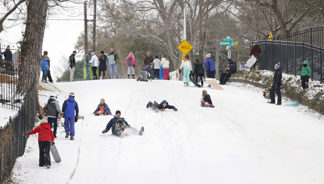  Kanak-kanak meluncur menuruni bukit selepas ribul salji membadai Fort Worth, Texas kelmarin. — Gambar AFP