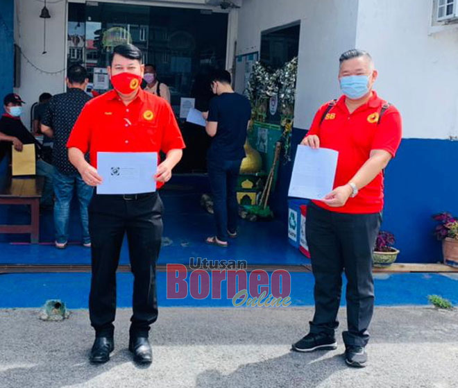  Kuan San (kanan) bersama Dr Rayong menunjukkan laporan polis dan lampiran bahan bukti selepas membuat laporan polis di Balai Polis Sungai Maong pagi semalam.