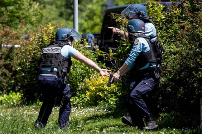  Anggota polis Perancis menghendap kawasan yang dipercayai tempat suspek bersenjatakan pisau bersembunyi selepas insiden serangan ke atas seorang anggota polis di La Chapelle-sur-Erdre. — Gambar AFP