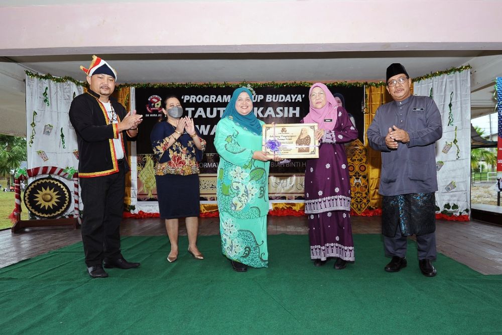 Guru Besar SK Wira Jaya Rosnah menyampaikan cenderamata kepada Rubiah.