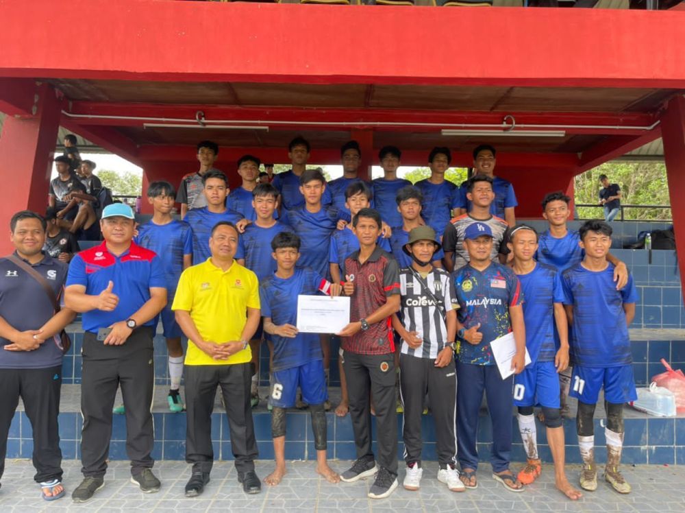  Roney Asmadul menyampaikan hadiah kepada pasukan SMK Tebobon Johan Kejohanan MSSD Kota Kinabalu B-18.
