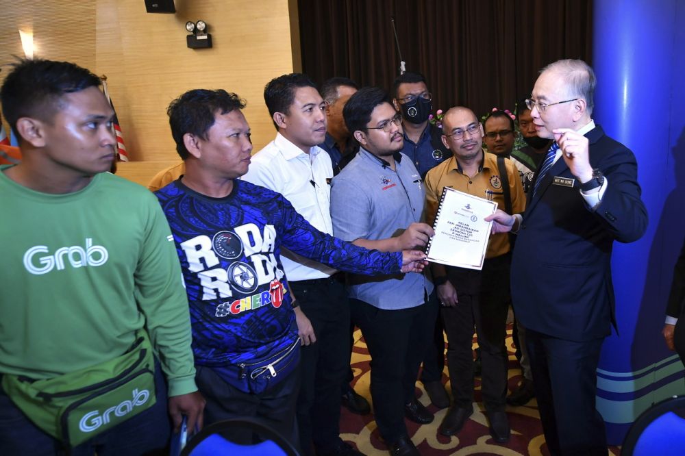 Wee Ka Siong menerima Pelan Penambahbaikan Eko-Sistem Ekonomi GIG P-Hailing daripada Persatuan Penghantar P-Hailing Malaysia yang diketuai oleh Presidennya Ts Zulhelmi Mansor (empat, kiri) selepas mengadakan sesi dialog dengan wakil E-Hailing dan P-Hailing di Kementerian Pengangkutan hari ini. - Gambar BERNAMA