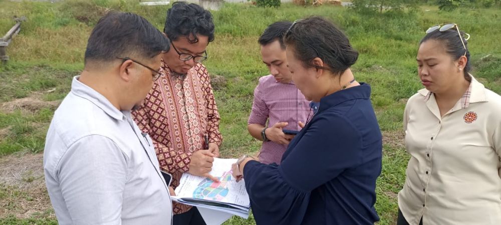 Juanda (dua kiri) bersama yang lain meneliti pelan pembangunan di kawasan Kuala Matu.