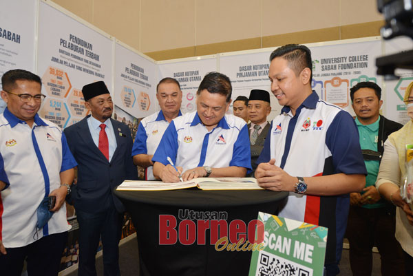  Mohd Ariffin (dua kanan) menandatangani buku pelawat di tapak pameran KYS dan diperhatikan Gulamhaidar (tiga kiri).