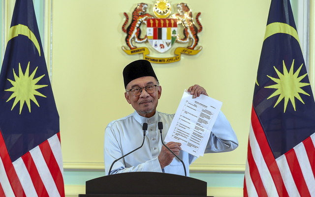  Anwar menunjukkan senarai pembentukan barisan Kabinet pada sidang media Pengumuman Kabinet Kerajaan Perpaduan di Bangunan Perdana Putra, malam tadi. - Gambar Bernama