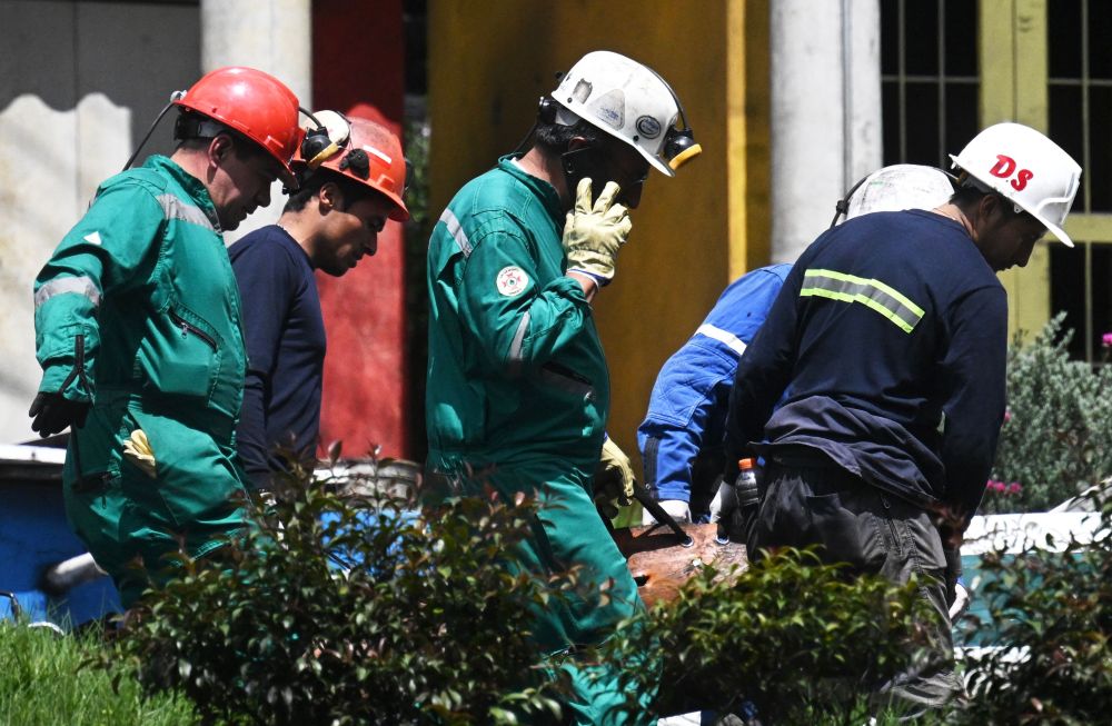 Anggota bomba mengangkat mayat pelombong yang terbunuh dalam letupan di lombong arang batu di bandar  Sutatausa kelmarin. — Gambar AFP