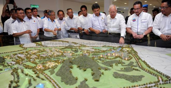 FASA AKHIR: Najib (tiga kanan) melihat pelan projek sempena lawatan kerja ke tapak pembangunan Pangkalan Udara Sendayan, semalam. — Gambar Bernama