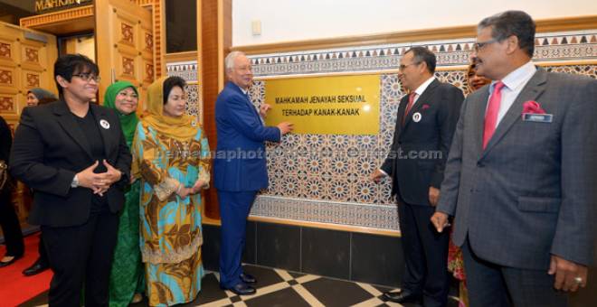 RASMI: Najib (empat kiri) menunjukkan plak Mahkamah Jenayah Seksual terhadap Kanak-Kanak selepas merasmikan mahkamah yang pertama seumpamanya di Malaysia dan Asia Tenggara itu di Istana Kehakiman di Putrajaya semalam. — Gambar Bernama