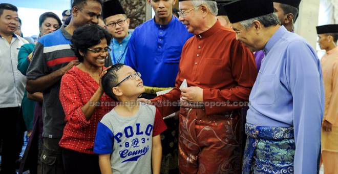 SELAMAT HARI RAYA: Najib (dua kanan) bersama Timbalannya Datuk Seri Dr Ahmad Zahid Hamidi (kanan) menyambut ketibaan para tetamu pada Majlis Rumah Terbuka Aidilfitri Perdana Menteri dan Jemaah Menteri 2017 di Seri Perdana di Putrajaya, kelmarin. — Gambar Bernama