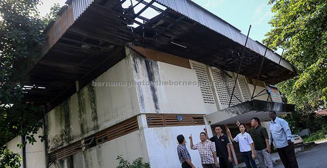 TERBIAR: Heng (tiga kanan) bersama penduduk sekitar kawasan Jalan Lombong, Taman Miharja menunjukkan keadaan bumbung sebuah dewan terbiar yang telah rosak dan dibimbangi akan runtuh ketika mengadakan sidang media di Kuala Lumpur, semalam. — Gambar Bernama