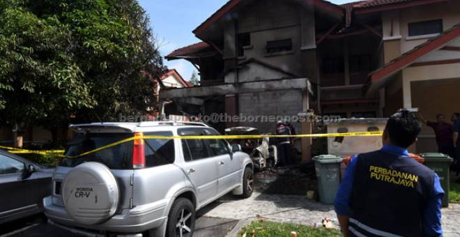 MASIH DISIASAT: Sebuah rumah yang didiami Nor Azman musnah dalam kejadian kebakaran di Putrajaya, semalam. — Gambar Bernama