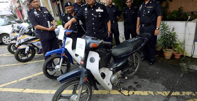 DIRAMPAS: Hamzah menunjukkan motosikal yang dirampas ketika sidang media di Balai Polis Taman Melawati dekat Kuala Lumpur, semalam. — Gambar Bernama