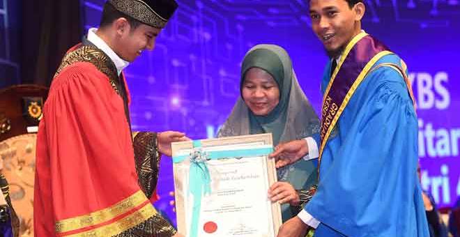 PENGIKTIRAFAN: Syed Saddiq (kiri) menyampaikan anugerah Graduan Terbaik Keseluruhan kepada Mohd Zaidi Abd Rahman (kanan) pada Majlis Konvokesyen Institusi Latihan Kemahiran Belia dan Sukan (ILKBS) Ke-14 di Pusat Konvensyen Antarabangsa Putrajaya (PICC), semalam. — Gambar Bernama