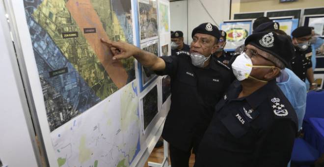 Mohamad Fuzi (kanan) melihat peta lokasi pencemaran Sungai Kim Kim yang ditunjukkan oleh Ketua Polis Johor Datuk Mohd Khalil Kader Mohd hari ini - Gambar Bernama 