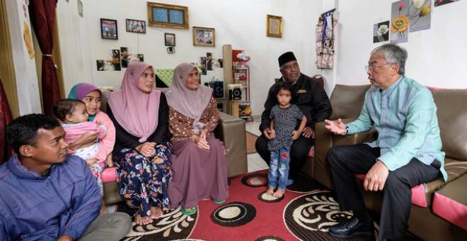 Yang di-Pertuan Agong Al-Sultan Abdullah Ri'ayatuddin Al-Mustafa Billah Shah berkenan bersama keluarga Shariff Bahsoon (dua,kanan) yang merupakan masyarakat Orang Asli ketika baginda melawat perkampungan Sungai Ruil hari ini. - Gambar Bernama 