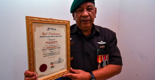 Mohd Rani menunjukkan sebahagian sijil penghargaan yang diterima berkhidmat mempertahankan tanah air dalam misi membanteras komunis. - Gambar BERNAMA