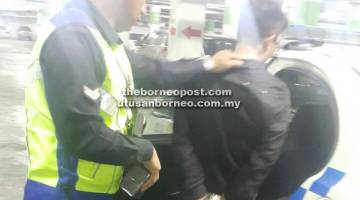 TIDAK BERHASIL: Suspek dibawa ke Balai Polis Pusat Miri setelah diserahkan pengawal keselamatan.