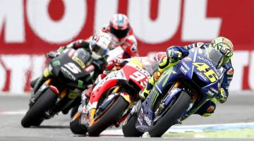 DI HADAPAN: Rossi mendahului pesaing yang lain di satu selekoh sempena MotoGP Belanda di Litar TT Assen. — Gambar AFP