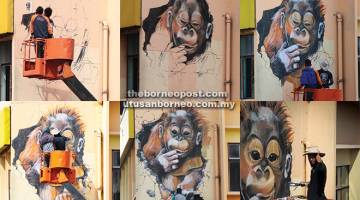 KREATIF: Gambar lukisan mural orang utan yang sedang dilukis oleh Siaw pada dinding Singgahsana Lodge di sini. — Gambar Simon Wan, WYK Photography.