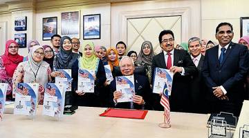 PERSIAPAN TERAKHIR: Najib dan Johari (tiga kanan) menunjukkan buku Laporan Ekonomi semasa meninjau persiapan terakhir Bajet 2018 di Kementerian Kewangan, Putrajaya, semalam. — Gambar Bernama